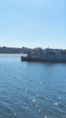 Street musician performs at Ternopil waterfront on sunny afternoon
