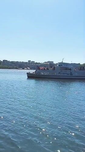Street musician performs at Ternopil waterfront on sunny afternoon