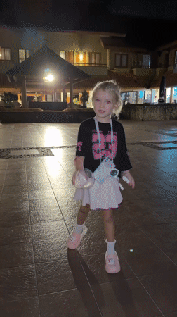 Children play in resort courtyard at night in Indonesia