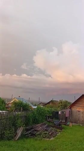 After-rain sunset captured across rural Novoilinsky gardens and backyards