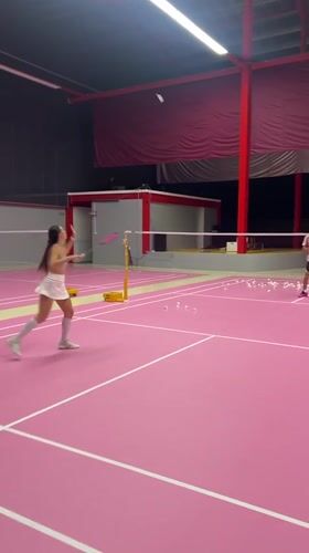Badminton match captured on pink court in Ko Samui