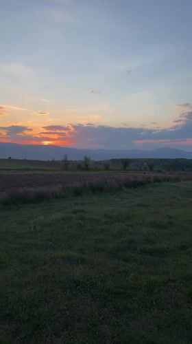 Sunset documented over rural waterscape in Blagoevgrad, Bulgaria
