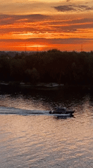 Volga River sunset from Samara's bridge, boats and warm skies