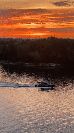 Volga River sunset from Samara's bridge, boats and warm skies