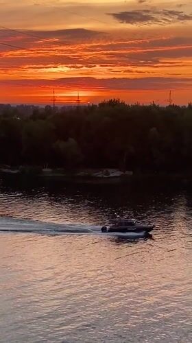 Volga River sunset from Samara's bridge, boats and warm skies