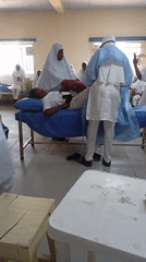 Medical training session with uniformed participants observed indoors