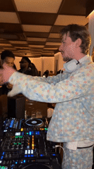 DJ in checkered outfit performs at London party