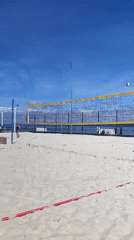 Beach volleyball game in full swing on a sunny day