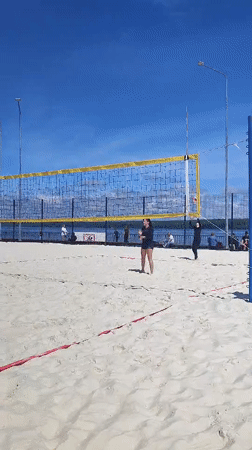 Beach volleyball game in full swing on a sunny day