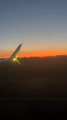 Passenger films Ryanair wing during twilight flight over Denmark