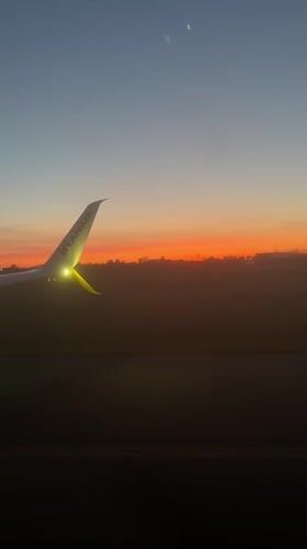 Passenger films Ryanair wing during twilight flight over Denmark