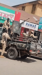 Three armed soldiers observed with military vehicle