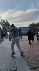 Man performs acrobatic stunts in public square