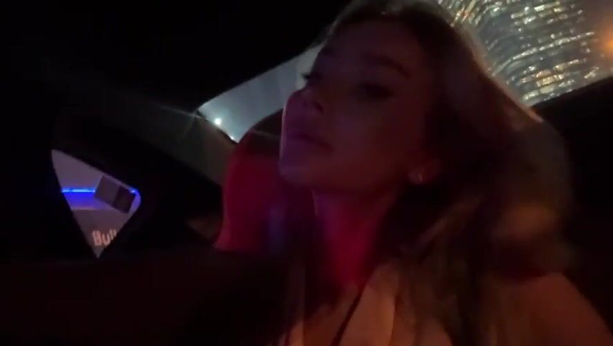 Woman travels by car through Dubai at night