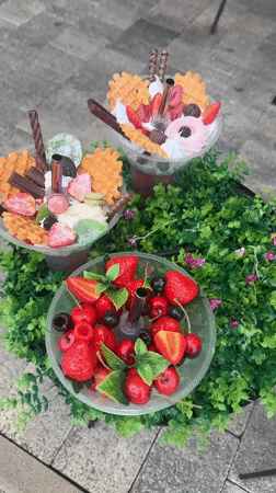 Elaborate desserts displayed on decorated platform in Sochi