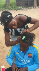 Outdoor hair braiding session in Badagry, Nigeria