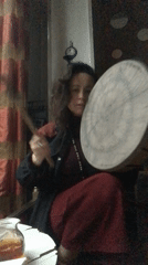 Woman plays frame drum indoors in Tbilisi