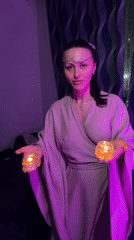 Woman with candles observed in purple-lit room in Russia