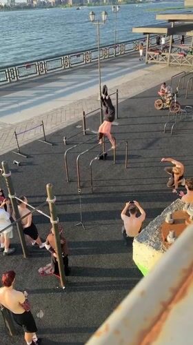 Calisthenics crew trains on outdoor bars by the water in Kazan