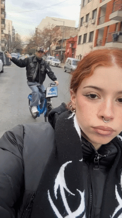 Two cyclists ride Ecobici rentals through Buenos Aires streets