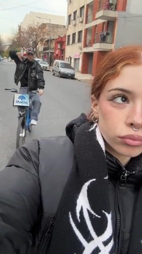 Two cyclists ride Ecobici rentals through Buenos Aires streets