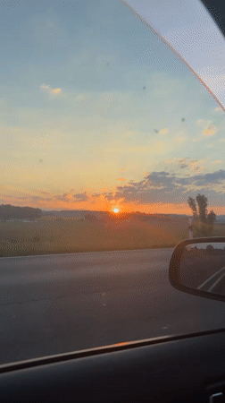 Motorist captures sunset view while driving near Lemgo, Germany
