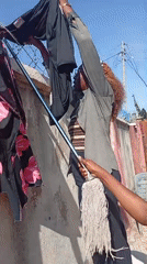 Everyday activity in a walled courtyard with barbed wire fencing