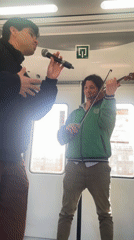 Street musicians perform in subway car in Barcelona area