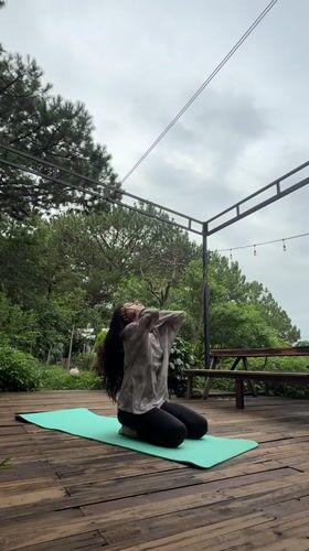 Outdoor yoga on a wooden deck in Da Lat's green hills