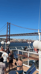 Cruise ship passes under Lisbon's 25 de Abril Bridge