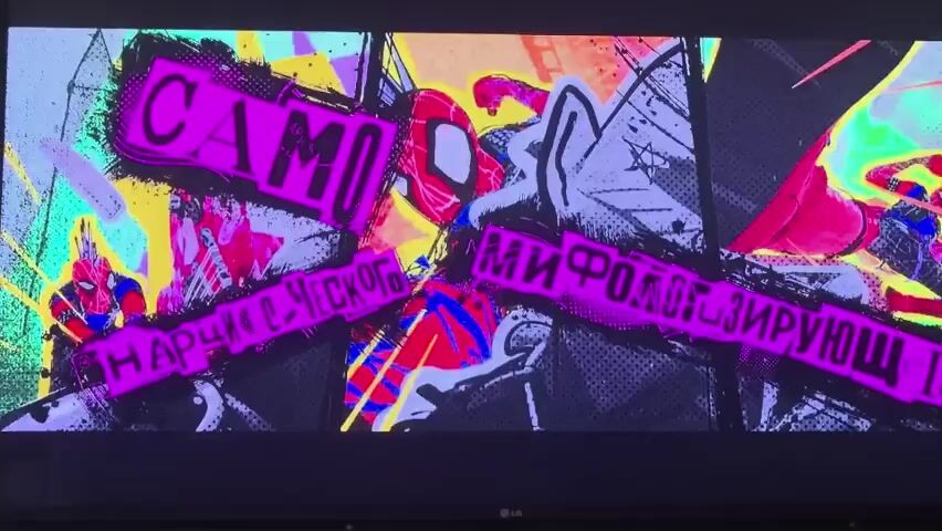 This media file appears to be a montage of animated scenes, likely from a film or television show.

The first scene features a vibrant, stylized graphic with bold pink lettering overlaying a comic-book-like background. Two figures, one of which resembles Spider-Man, are visible within the graphic. Text in a Cyrillic alphabet is prominent, with words like "САМО" and "ВЗТОКРАТА" clearly legible.

The second scene presents a more subdued graphic against a dark, textured background. A large, stylized symbol, possibly an emblem or logo, is depicted in white with pink accents. Cyrillic text, including "ШАУК ПАНК," is displayed here as well.

The third scene shifts to a more traditional animation style. A character in a black suit with a glowing red spider emblem sits in a dimly lit room, bathed in blue and purple light. The setting appears to be an office or workspace, with desks and monitors visible. The character's posture and the glowing emblem suggest a dramatic or intense moment.

The final scene is a dynamic, action-oriented animation. A character, possibly a superhero, is shown in mid-air, suspended by a web. The background is a riot of color, dominated by bright pink and electric blue, suggesting an urban or futuristic setting. Several smaller figures are visible in the distance, also in motion.

The overall impression is one of high-energy animation, likely with a superhero or action theme, incorporating graphic design elements and Cyrillic text. The emotional tone shifts from bold and graphic to dramatic and action-packed. No specific time of day or weather is discernible, but the settings range from stylized graphics to what appears to be a contemporary or futuristic urban environment.