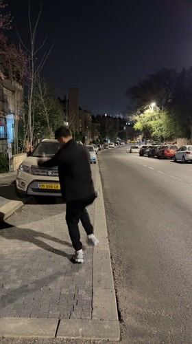 Men dance, take selfies on Jerusalem street at night