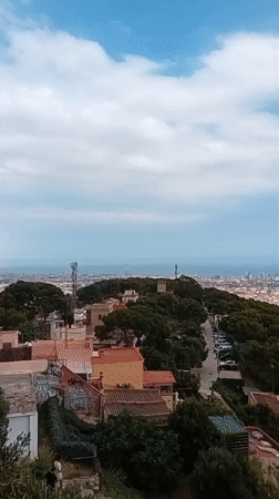 Panoramic Barcelona cityscape captured from hilltop during afternoon hours
