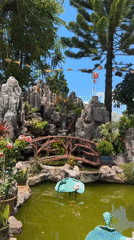 Visitor documents serene Buddhist temple grounds in Vietnamese highlands