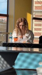 Woman unwraps sandwich at Saint Petersburg indoor location