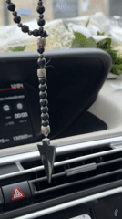 Beaded car accessory with pendant observed in Milan vehicle