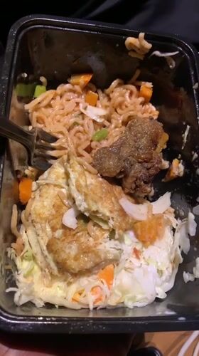 Person holds prepared noodle meal in Gura Top, Nigeria