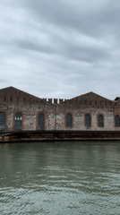 Historic Venice canal buildings filmed from boat on overcast morning