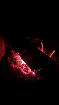 Fireplace burns with logs and embers in Elena, Bulgaria