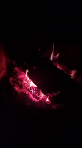 Fireplace burns with logs and embers in Elena, Bulgaria