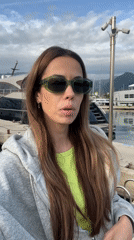 Woman gestures at luxury yacht marina in Bar, Montenegro