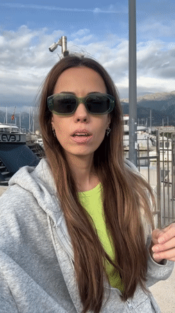 Woman gestures at luxury yacht marina in Bar, Montenegro