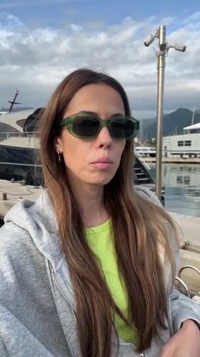 Woman gestures at luxury yacht marina in Bar, Montenegro