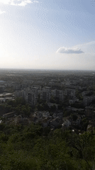 Elevated view captures Plovdiv cityscape under hazy afternoon skies