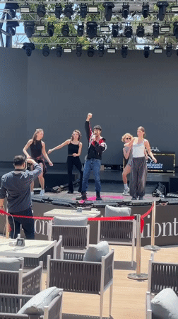 Male singer performs with dancers at outdoor Kemer venue