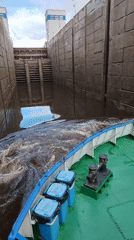 Vessel transits industrial canal lock marked 15.7