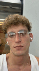 Indoor close-up with glasses, earbuds, and a nose ring in Madrid