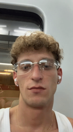 Indoor close-up with glasses, earbuds, and a nose ring in Madrid