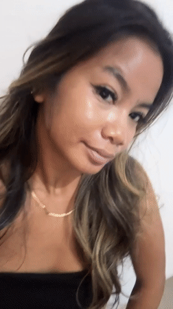 Woman takes multi-device selfies in Sukawati using cracked tablet