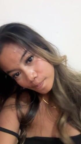 Woman takes multi-device selfies in Sukawati using cracked tablet